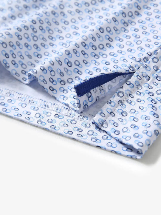 Hem slit detail of BLUE LOOP CHAIN Performance Quick Dry Print Golf Polo highlighting stitching and finish