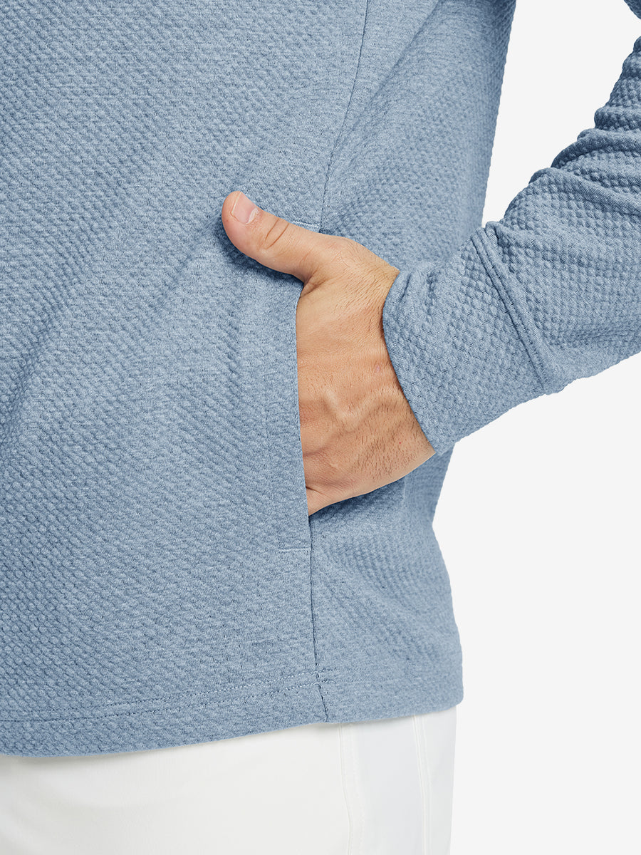 Close-up of pocket detail, single hand inside texture solid hoodies pullover, casual style in blue heather.