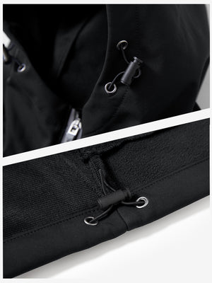 Close-up of zipper and button details on reflective hooded softshell jacket in black.