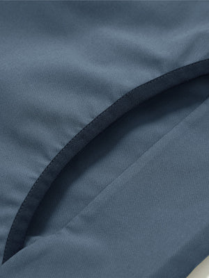 Side pocket detail of the mock neck quarter button golf pullover in misty blue, practical design feature.