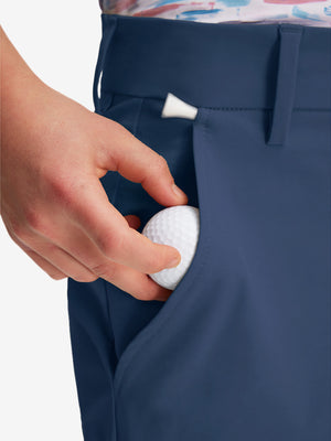 Detail: pocket of dark blue boys lightweight dry fit flat front golf shorts