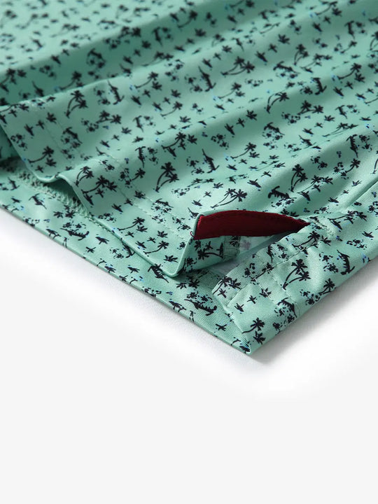 Detail view of the mint seaside palm pattern polo shirt, focusing on the neat hem opening and refreshing design.