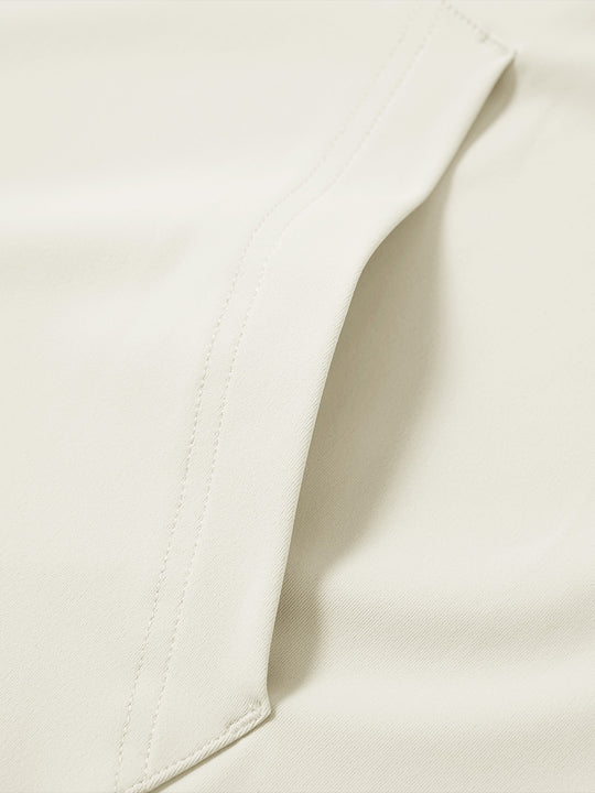 Close-up of single pocket detail on youth long sleeve hoodied with kangaroo pocket in cream, showing stitching.