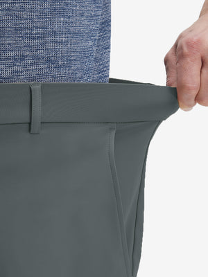 Detail view of elastic waistband on dark grey flat front golf joggers pants with belt loops