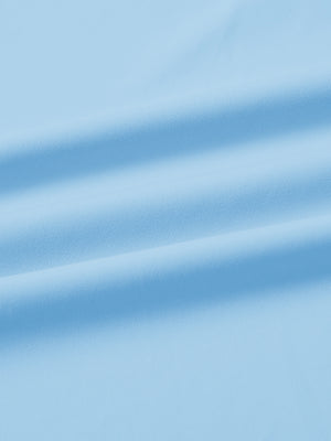 Fabric close-up of print collar quarter zip golf vest, smooth material with subtle texture in light blue