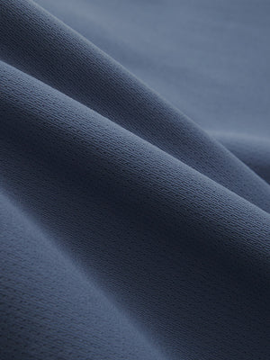 Close-up texture of misty blue breathable running shorts with 4 zipper pockets fabric showing weave detail