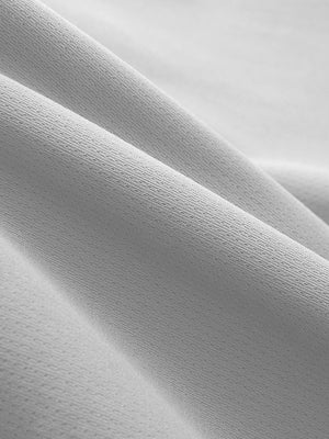 Close-up texture of khaki grey breathable running shorts with 4 zipper pockets fabric showing weave detail