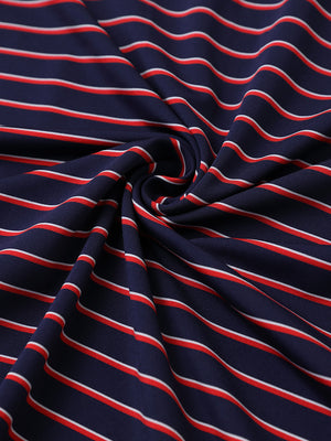 Close-up fabric view of youth performance golf polos, smooth texture with breathable navy/red stripe finish