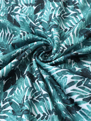 Close-up of dark green leaf golf performance print boys golf polo fabric showing moisture-wicking texture 
