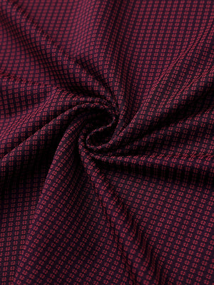 Close-up of red elegant performance jacquard polo fabric showing refined texture and subtle pattern.
