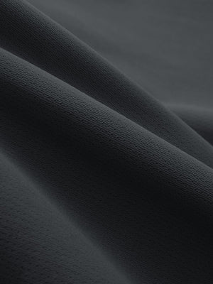Close-up texture of dark grey breathable running shorts with 4 zipper pockets fabric showing weave detail