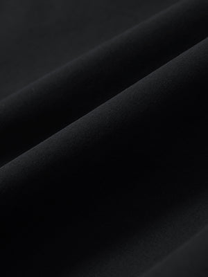 Macro view of the black stretch soft flat front dress golf shorts fabric, showcasing the smooth texture