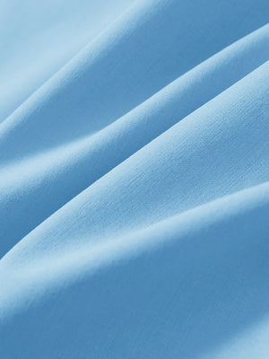 Macro view of the light blue stretch soft flat front dress golf shorts fabric, showcasing the smooth texture