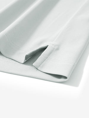Close-up of the hem vent on the silver gray ventilated pique performance polo, showing the side split for movement