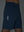 Detail of glow in the dark feature on misty blue breathable running shorts with 4 zipper pockets