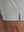 Detail view of hem on khaki grey breathable running shorts with 4 zipper pockets