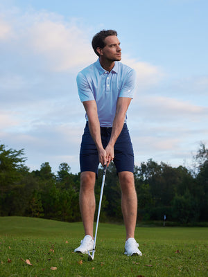 Model in light blue your favorite jacquard polo preparing to tee off, full-body shot