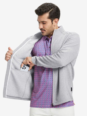 Model front half body lifting jacket, hand in inner pocket, textured insulated winter jacket, light grey heather.