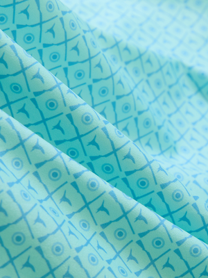 Close-up of pea green goose lightweight stretch upgraded print golf polo shirts, showcasing texture and print details.