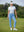 Woman wearing Women's Ultra-stretch Quick Dry Sweatpants with Ankle Zips in misty blue, holding golf club on course