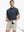 Full body front view of model wearing GREY NAVY Your Favorite Jacquard Polo, holding a golf club